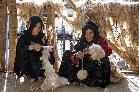 Afghan women weave wools for making carpets at a traditional carpet factory in Kabul, Afghanistan. (Photo | AP)
