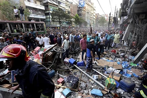 Onlookers gather outside the site of an explosion, in Dhaka, Bangladesh, Tuesday, March 7, 2023. (Photo | AP)