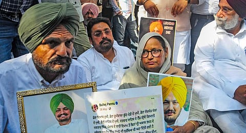 Parents of singer Sidhu Moose Walla stage a protest outside Punjab Assembly demanding justice for their son, in Chandigarh, Tuesday, March 7, 2023.(Phot | PTI)