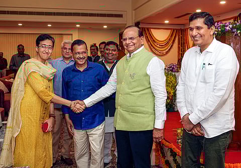 Delhi Lt Governor VK Saxena and Chief Minister Arvind Kejriwal (2nd from left) with newly sworn-in Delhi Cabinet Ministers Atishi Marlena (left) and Saurabh Bharadwaj. (Photo | PTI)