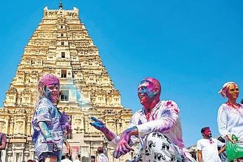 Foreign tourists celebrate Holi in front of Virupaksha temple in Hampi on Wednesday | Shivashankar Banangar