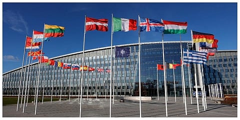 Flags flutter in the wind outside NATO headquarters in Brussels. (Photo |AP)
