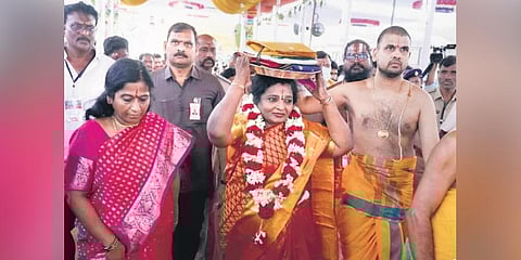 Governor Tamilisai Sounderarajan carries pattu vastralu on her head to be offered to Lord Rama and Sita Devi in Bhadrachalam on Friday
