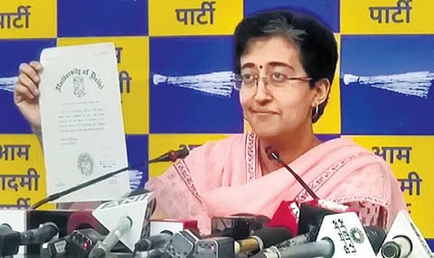Atishi displays her educational degrees to the media on Sunday. (Photo | Express)