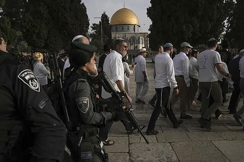 Israeli police escort Jewish visitors marking the holiday of Passover to the Al-Aqsa Mosque compound in the Old City of Jerusalem, April 9, 2023. (Photo | AP)