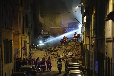 Firefighters work after a building collapsed early Sunday, April 9, 2023 in Marseille, southern France. (Photo | AP)