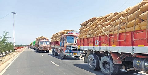 Lorries laden with fine variety of rice wait at the Chillepally  in Hyderabad on Sunday for the police to allow them to proceed. 