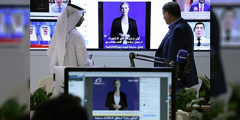 Journalists watch an introductory video by the 'artificial intelligence' anchor Fedha on the Twitter account of Kuwait News service, in Kuwait City on April 9, 2023. (Photo | AFP)