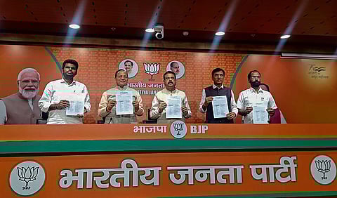 Union Ministers Dharmendra Pradhan and Mansukh Mandaviya with party leaders release BJP's first list of 189 candidates for the Karnataka assembly polls, April 11, 2023. (Photo | PTI)