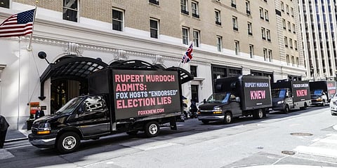 Truck billboards drive in front of the Palace Hotel calling out Fox News' election denial scheme in San Francisco, on March 08, 2023. (Photo | AFP)