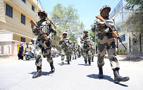 ​  Border Security Force personnel and local police take out a route march in Ulsoor  in Bengaluru on Monday, ahead of the Assembly elections. (Photo | Nagaraja Gadekal, EPS)  ​