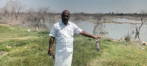 AIADMK councillor Palanisamy holding a dead fish | EXPRESS