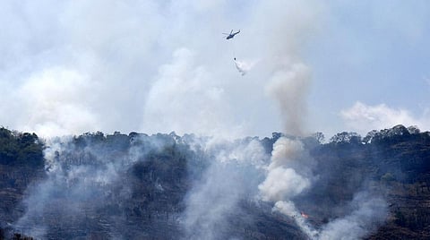 The helicopter which was fitted with a bambi bucket, sprayed over 22,000 litres of water and doused the fore in two major zones. (Photo | S Senbagapandiyan)