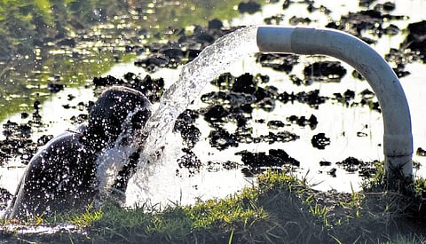 An old man taking shower at a water pump | Madhav K
