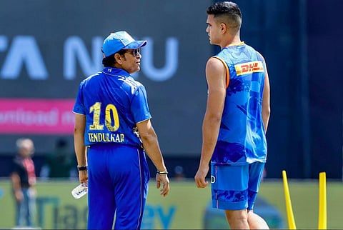 Former cricketer Sachin Tendulkar with his son and Mumbai Indians player Arjun Tendulkar. (Photo | PTI)