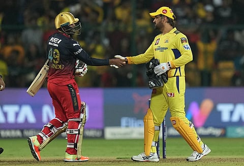 Chennai Super Kings captain MS Dhoni greets Royal Challengers Bangalore batter Wanindu Hasaranga. (Photo | PTI)
