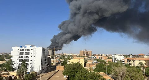 A column of smoke rises behind buildings near the airport area in Khartoum on April 19, 2023, amid fighting between the army and paramilitaries following the collapse of a 24-hour truce. (Photo | AFP)