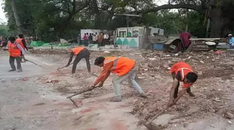 PWD workers remove debris during demolition work at a dargah on the Zakhir Hussain Marg in Delhi (Photo  | PTI)