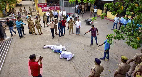 Special Investigation Team (SIT) and the forensic team recreate the crime scene, where three assailants shot dead gangster-turned-politician Atiq Ahmed.(Photo | PTI)