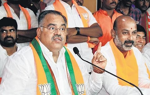 BJP national general secretary Tarun Chugh addresses the media along with BJP State president Bandi Sanjay at the party’s State office at Nampally in Hyderabad on Wednesday