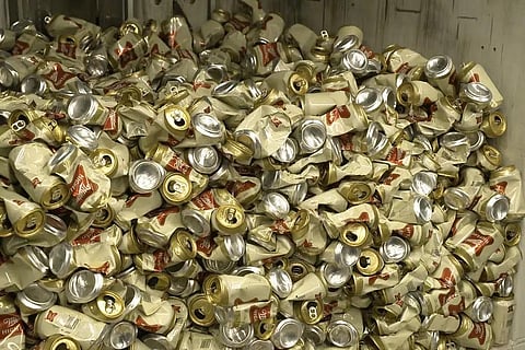 In this image provided by Comite Champagne, cans of Miller High Life beer sit in a container after being crushed at the Westlandia plant in Ypres, Belgium, Monday, April 17, 2023. (Photo | AP)