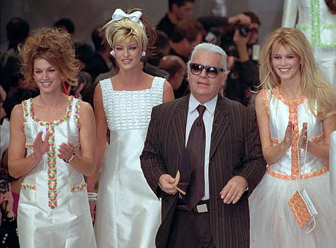 German designer Karl Lagerfeld joins models after the presentation of his 1996 spring-summer ready-to-wear fashion collection for Chanel in Paris on Oct. 19, 1995. (Photo | AP)