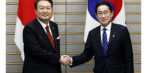 South Korean President Yoon Suk Yeol, left, and Japanese Prime Minister Fumio Kishida shake hands ahead of their bilateral meeting at the prime minister's office in Tokyo, March 16, 2023. (Photo | AP)