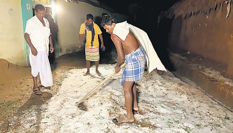 Locals clearing hailstones from a road in a village of Nabarangpur district. (Photo | Express)