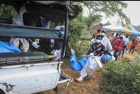Police and local residents load the exhumed bodies of victims of a religious cult into the back of a truck in the village of Shakahola, in southeastern Kenya. (Photo | AP)