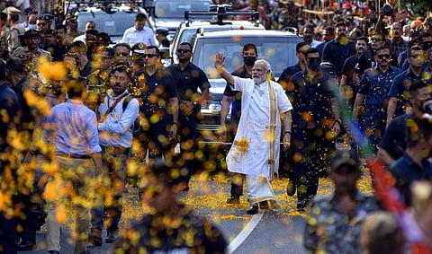 Prime Minister Narendra Modi waves at the crowd as he walks through a street in Thevara during a roadshow in Kochi. (Photo | A Sanesh, EPS)