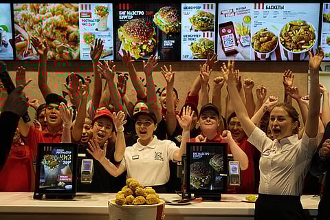 Employees of Rostic's restaurant in Tverskaya street celebrate opening ceremony in Moscow, Russia. (Photo | AP)