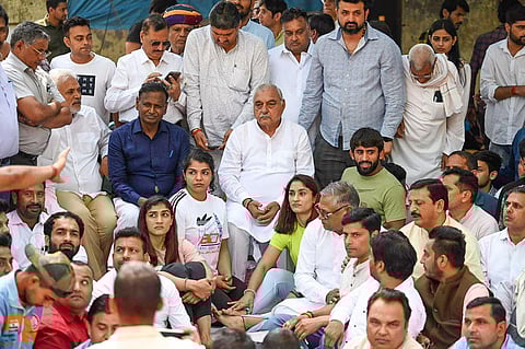 Former Haryana chief minister Bhupinder Singh Hooda with wrestlers Vinesh Phogat, Sakshi Malik, Bajrang Punia and others during their protest on April 25, 2023. (Photo | PTI)