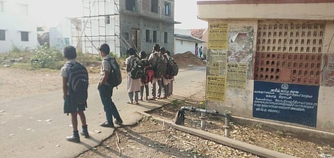 Students waitfor an auto rickshaw after missing Bus 17A in Perambalur. (Photo | Express)