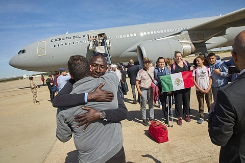 In dramatic evacuation operations, convoys of foreign diplomats, teachers, students, workers and families from dozens of countries wound past combatants at tense front lines in the capital of Khartoum to reach extraction points. In this photo provided by the Spanish Defence Ministry passengers from Sudan disembark from a Spanish Air Force aircraft at Torrejon Air Base in Madrid. (Photo | AP)