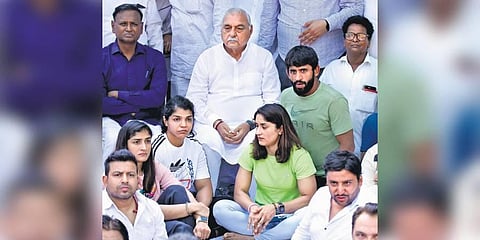 Former Haryana CM Bhupinder Singh Hooda (C) with wrestlers Vinesh Phogat, Sakshi Malik, and Bajrang Punia during the protest at Jantar Mantar on Tuesday. (Photo | Parveen Negi, EPS)