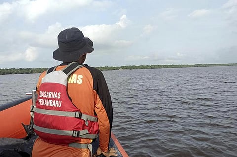 A rescuer scans the horizon during the search for victims of a sinking speedboat in Indragiri Hilir Regency, Indonesia. (Photo | AP)