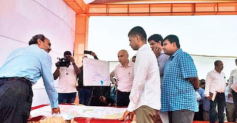 Pandian and other officials at the proposed steel plant site in Kendrapara | Express