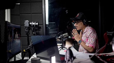Ghost Radio station host Jack Watcharapol Fukjaidee greets the listeners as he broadcasts live from his studio in Bangkok.