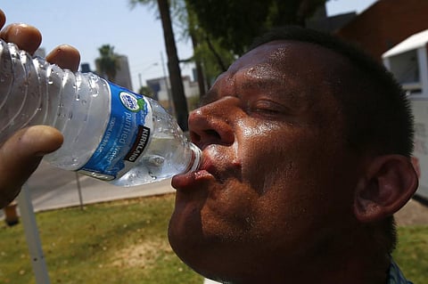 In this June 19, 2017 file photo Steve Smith takes a drink of water as he tries to keep hydrated and stay cool as temperatures climb to near-record highs, in Phoenix.  (File photo | AP)