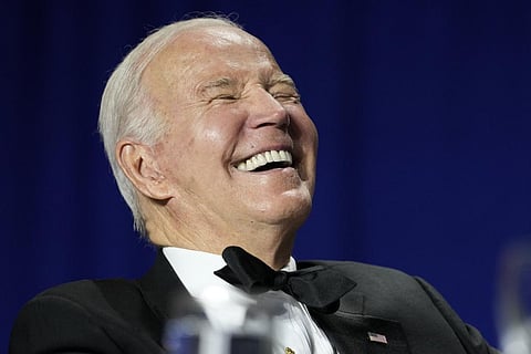 President Joe Biden laughs as comedian Roy Wood Jr., a correspondent for 'The Daily Show,' speaks during the White House Correspondents' Association dinner at the Washington Hilton. (Photo | AP)