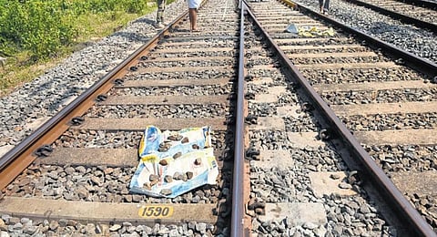 Police cover the spot, where the body of a person in the train attack incident was recovered, with a sack.(Photo | Express)