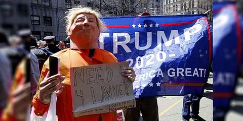 A protestor impersonates former US president Donald Trump in front of Trump supporters outside the Manhattan District Attorney's office in New York on April 4, 2023. (Photo | AFP)