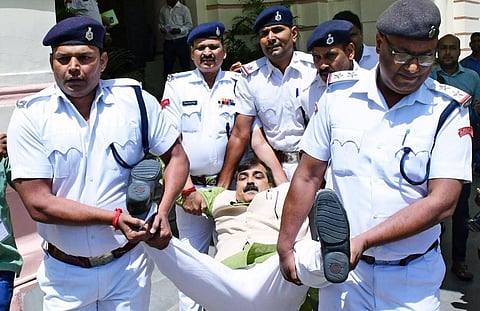Marshals take away BJP MLA Jivesh Mishra from the Bihar Assembly for causing a ruckus during the Budget Session, in Patna on Wednesday. (Photo | ANI)