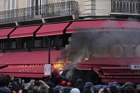 The awning of the La Rotonde restaurant burns during a demonstration Thursday, April 6, 2023 in Paris. (Photo | AP)