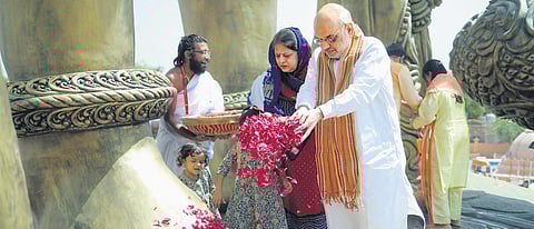 Union Home Minister Amit Shah offers flowers at Lord Hanuman’s idol after unveiling the 54-ft-tall statue at Salangpur, Gujarat on Thursday. (Photo | PTI)