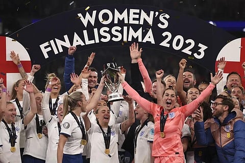England's Leah Williamson and goalkeeper Mary Earps,center right, raise the trophy after winning a penalty shootout to clinch the Women's Finalissima soccer match, April 6, 2023. (Photo | AP)