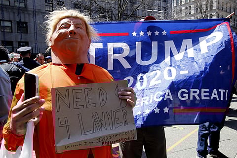 A protestor impersonates former US president Donald Trump in front of Trump supporters outside the Manhattan District Attorney's office in New York on April 4, 2023. (Photo | AFP)