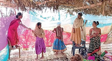 A group of Kandha women decorating Mangalpur village with sarees.