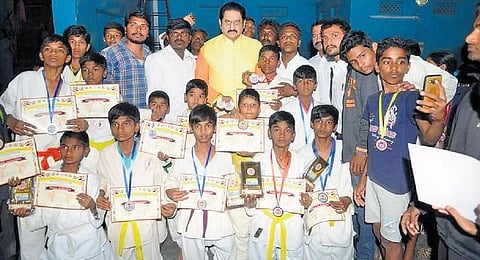 Chinna Lakshmaiah along with his students at a karate tournament in Kurnool I Express