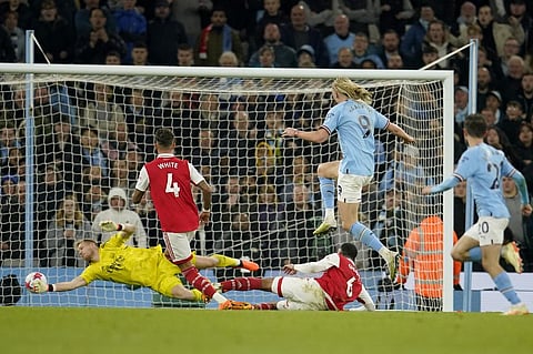 Manchester City's Erling Haaland, center, scores his side's fourth goal during the English Premier League soccer match between Manchester City and Arsenal at Etihad stadium. (Photo | AP)